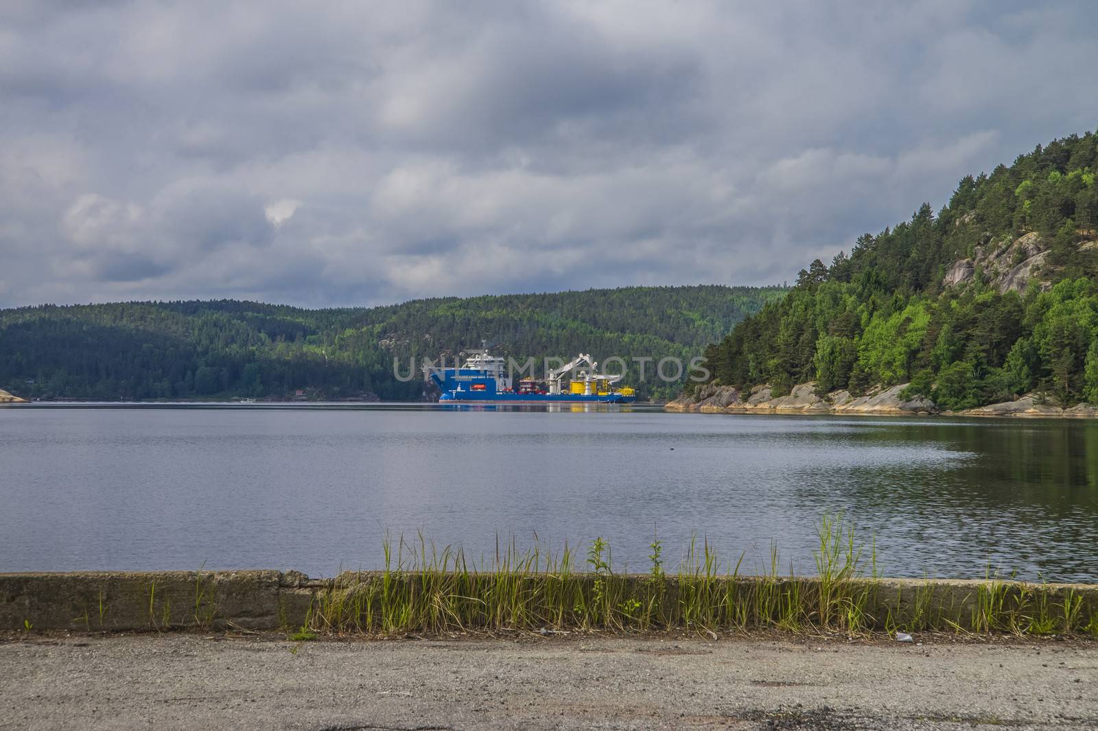 North sea giant is a large offshore supply ship. The picture is shot from the port of Halden, Norway and out towards Iddefjord where the ship is at anchor.