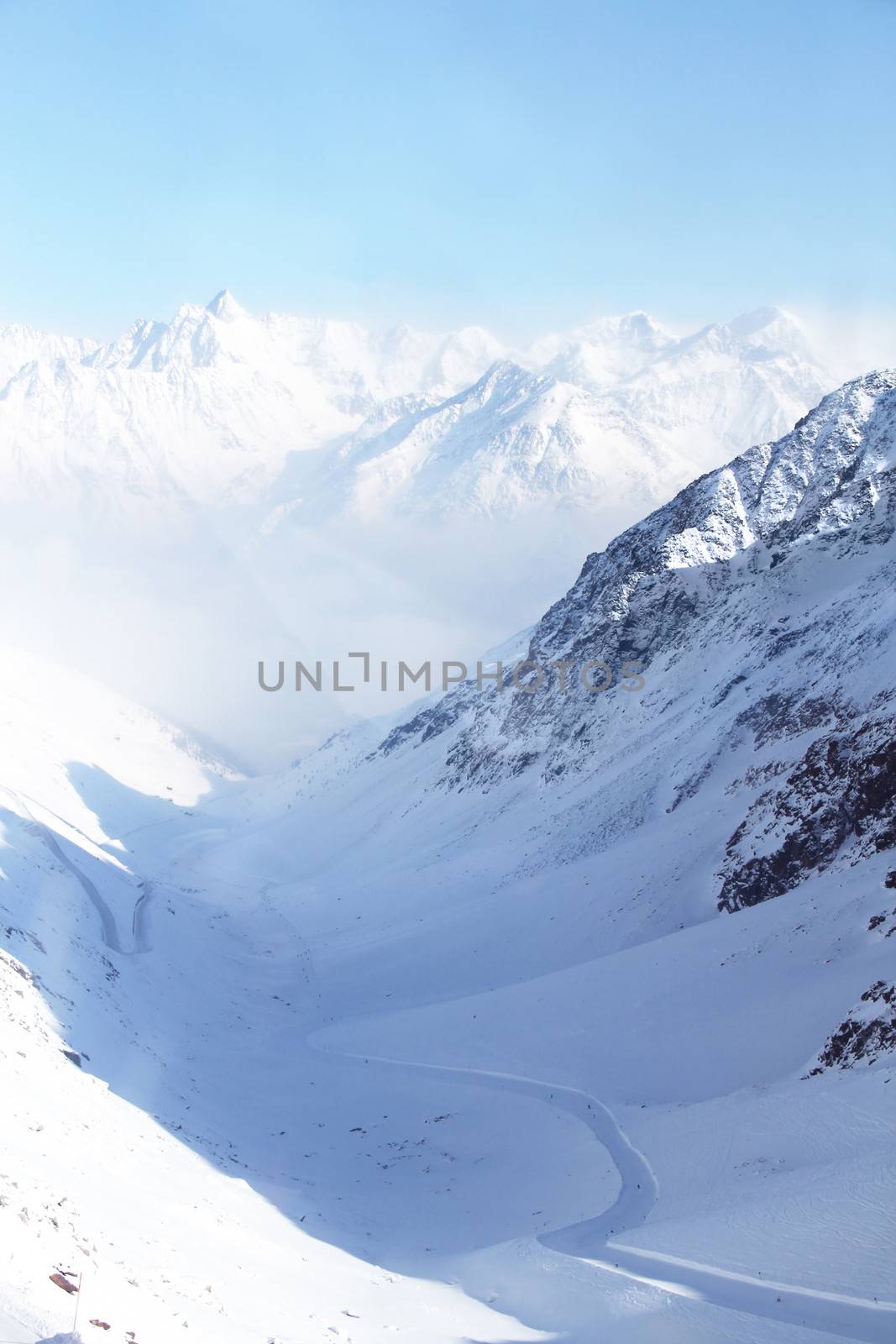 Mountain peaks of winter alps under blue sky