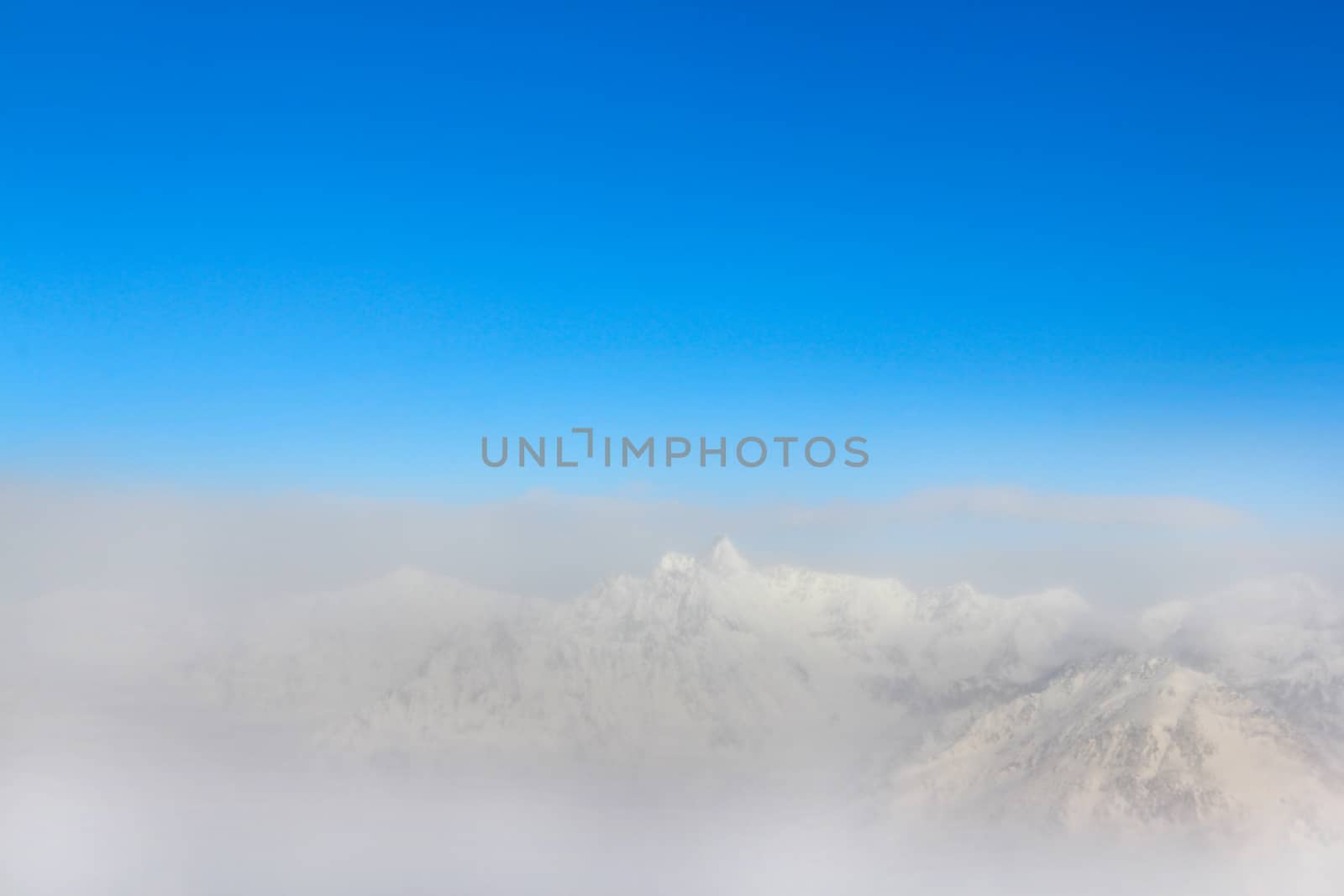 Beautiful panorama of foggy mountain peaks in winter