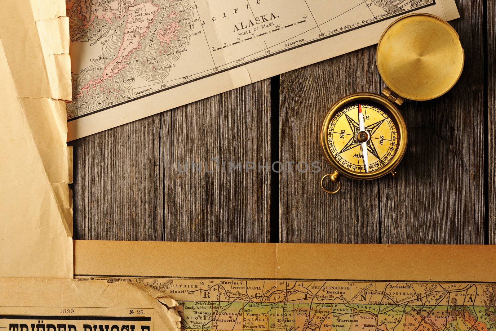 Antique brass compass over old map