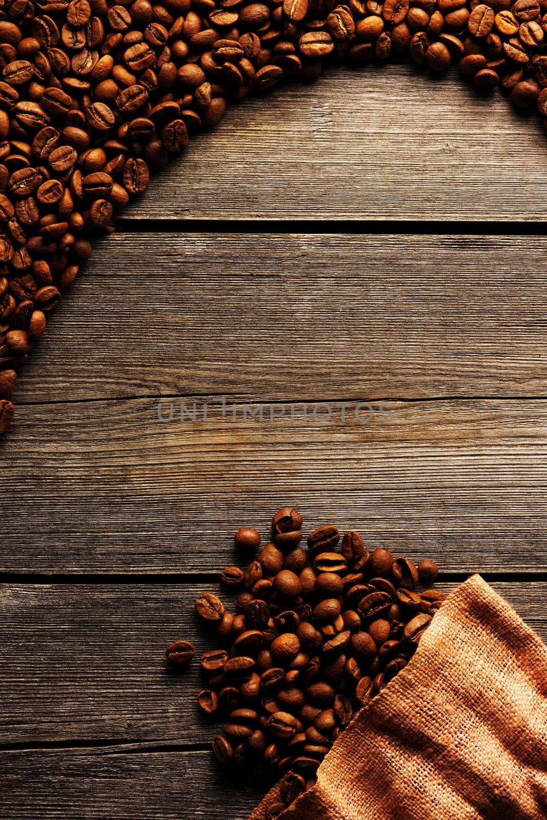 Coffee beans and bag over wooden background