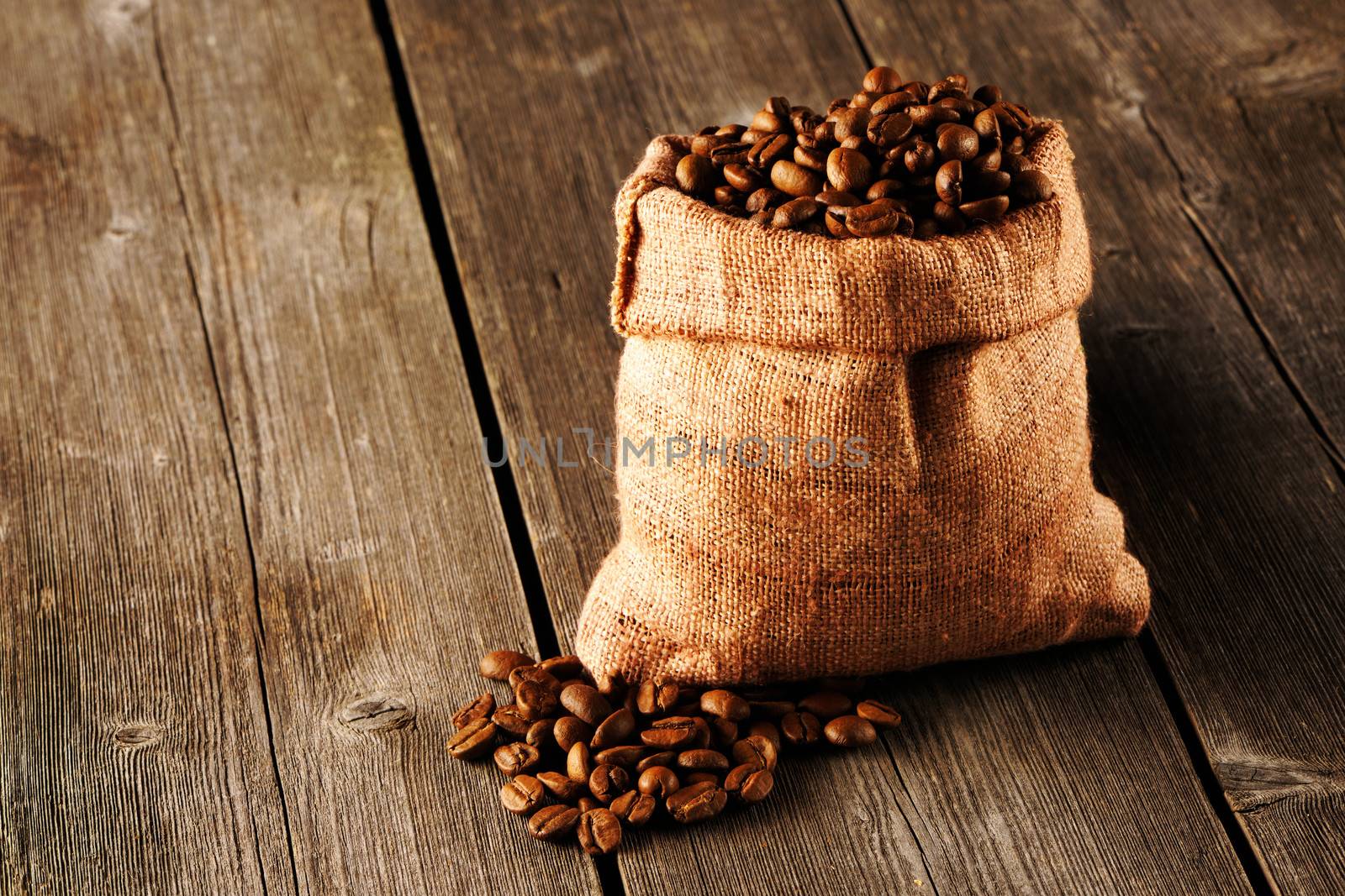 Coffee beans in bag on wooden table