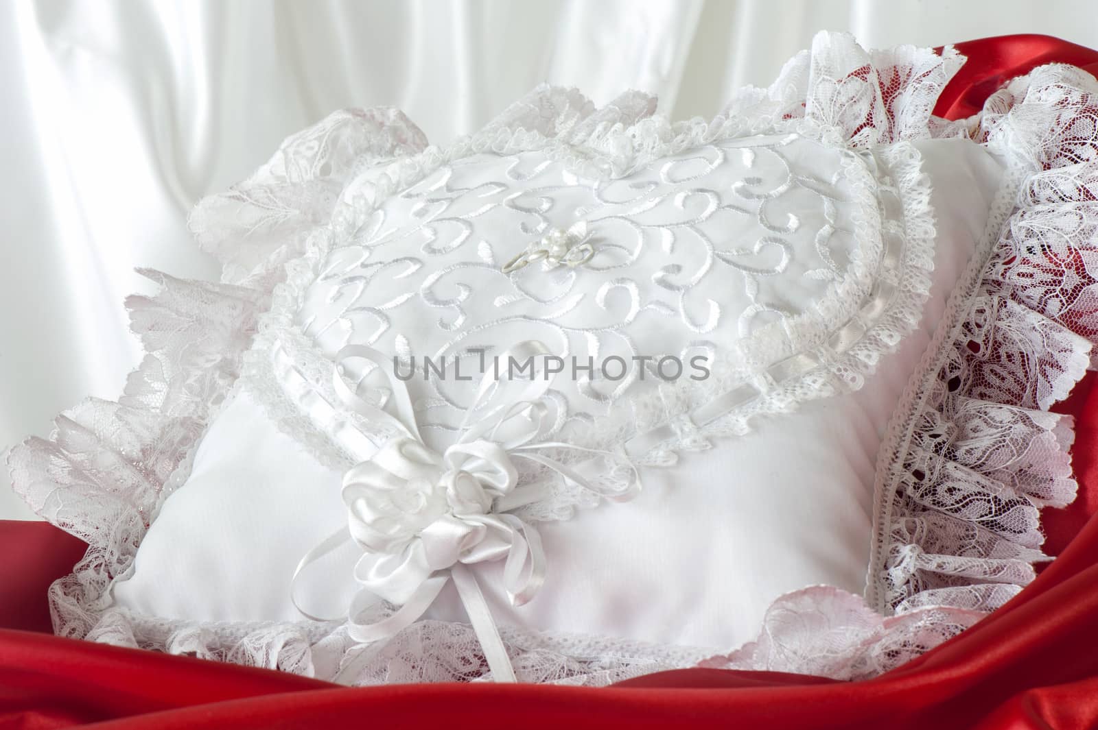 a whitw pillow for a wedding rings