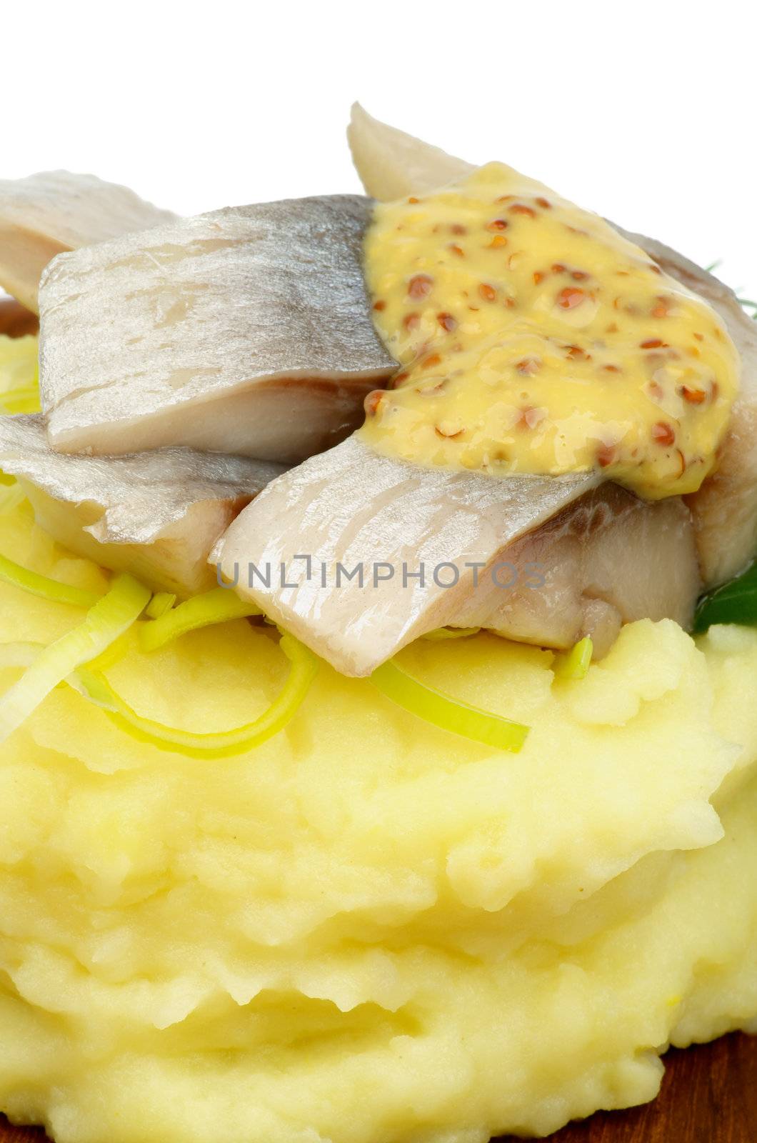 Delicious Piquant Herring on Mashed Potato and Mustard closeup