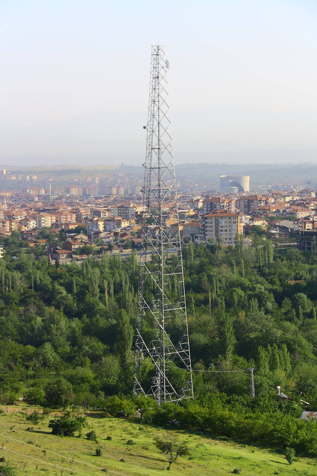 mobile phone antenna on the hill of city with city view