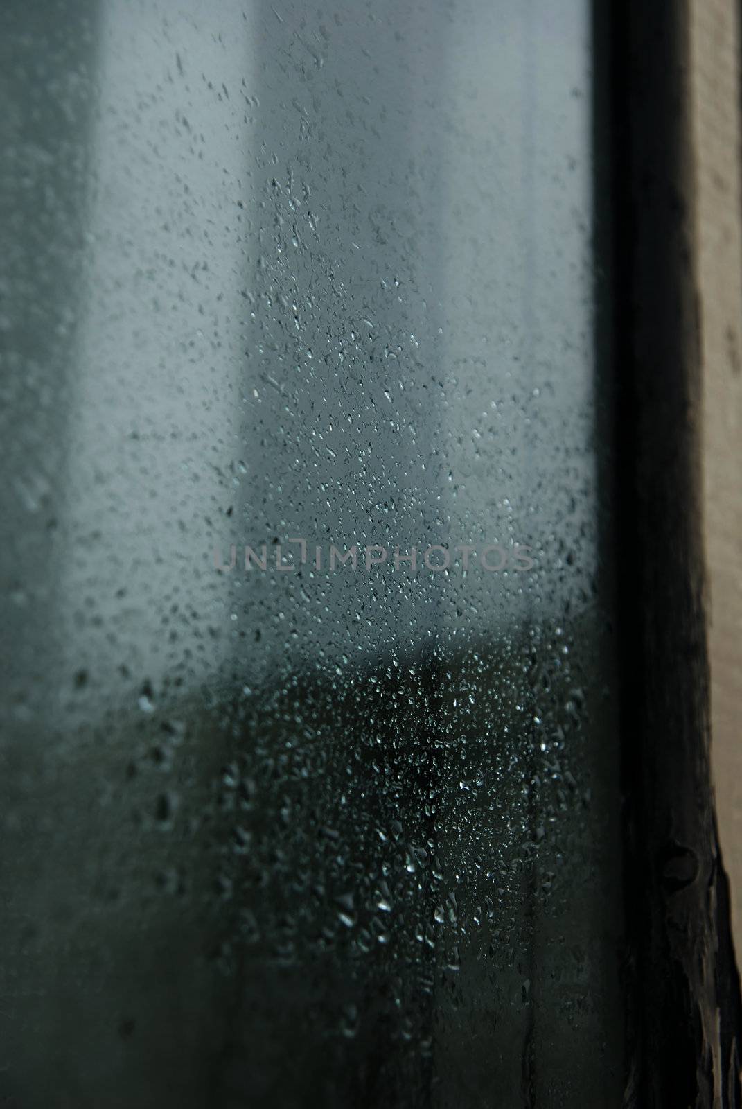 Close-up photo of the rain drops on a glass of window