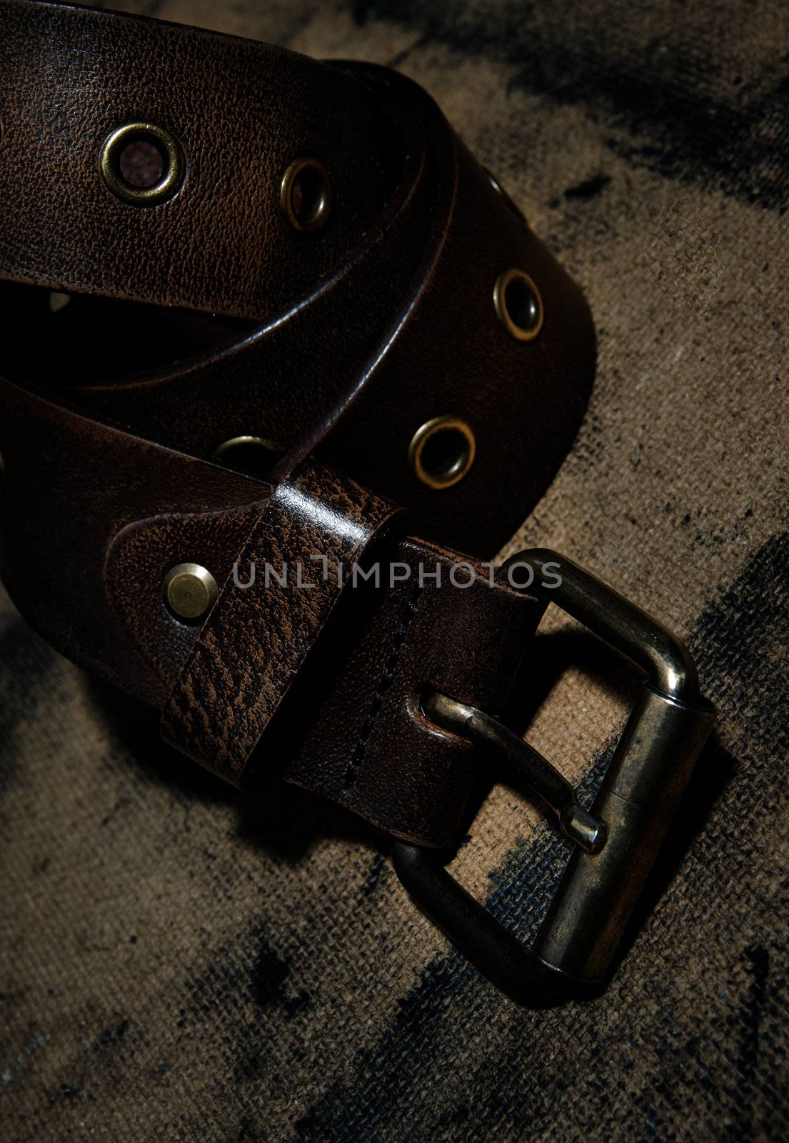 Close-up photo of the leather belt on textured background