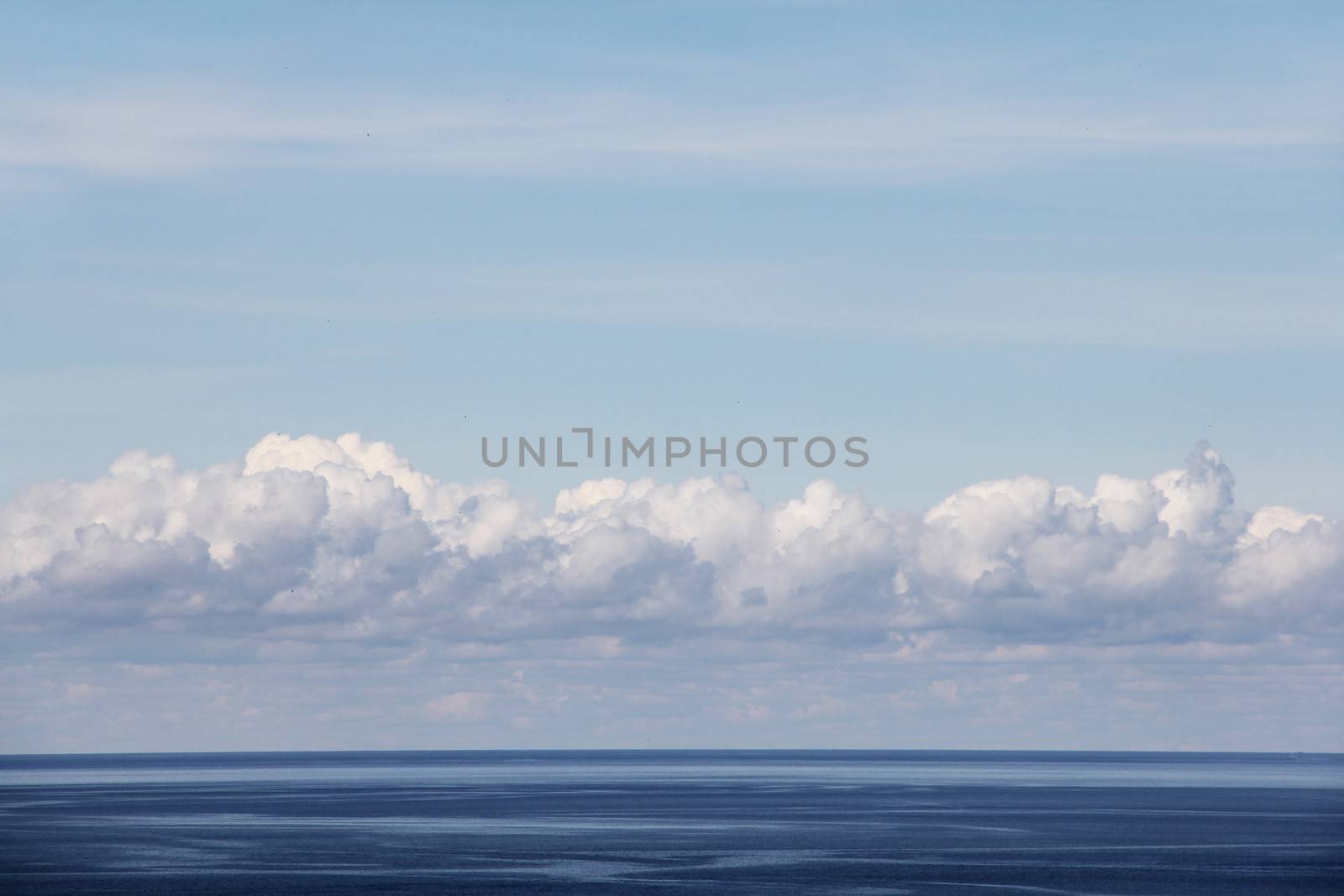 Blue ocean and bright sky with beautiful clouds