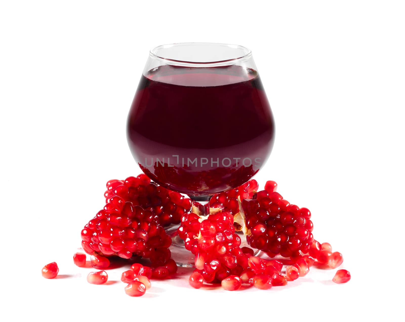 Pomegranate juice and seeds isolated on white