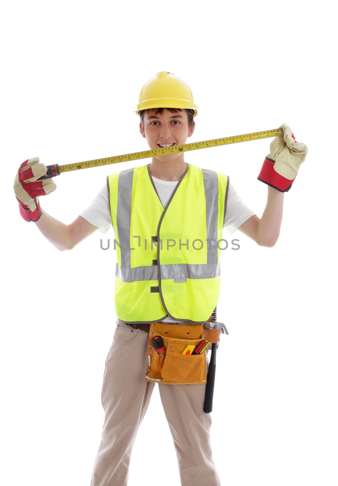 Apprentice or student carpenter or builder smiling, with tools and measuring tape.  White background.