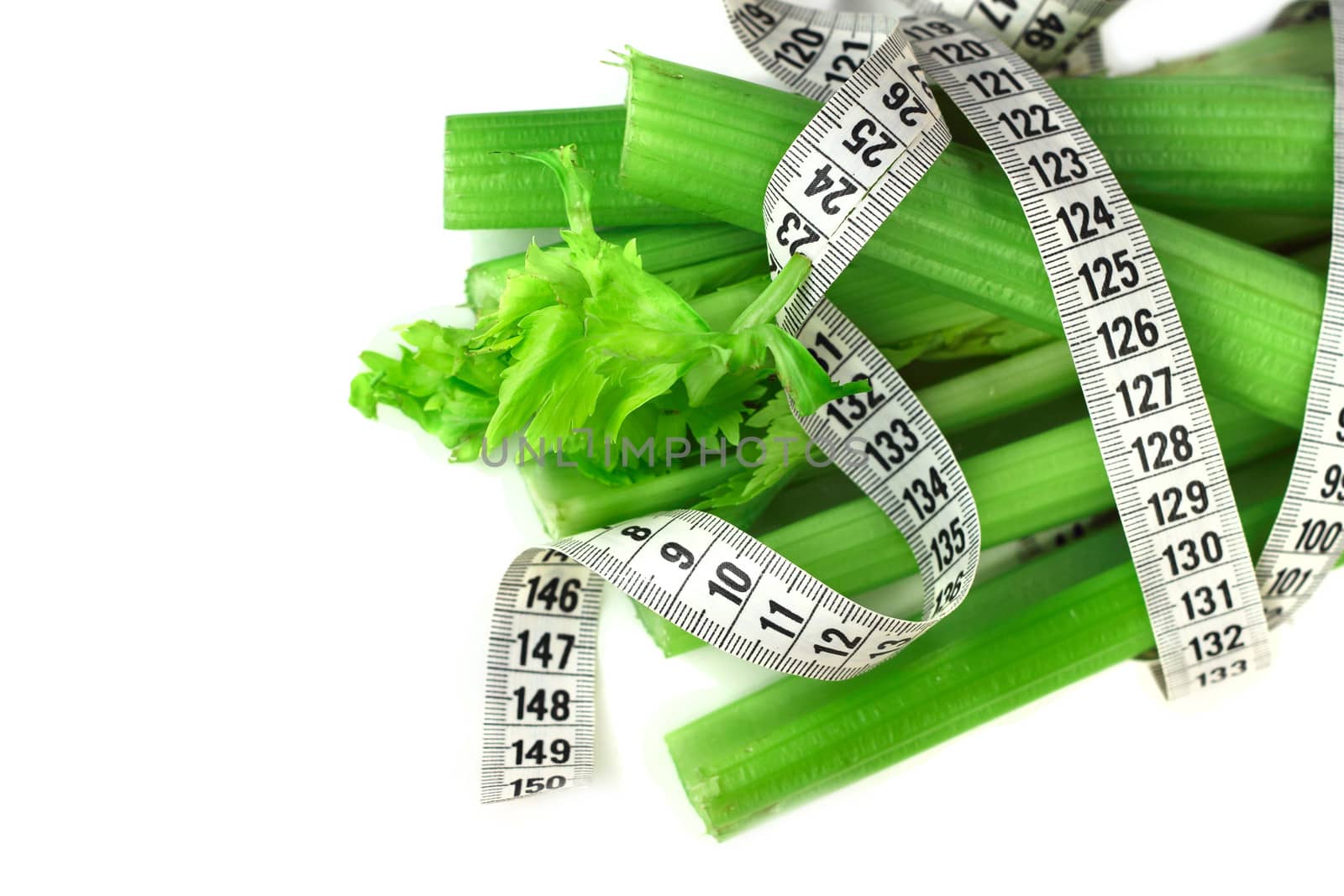 Celery and measure tape diet concept isolated on white corner composition