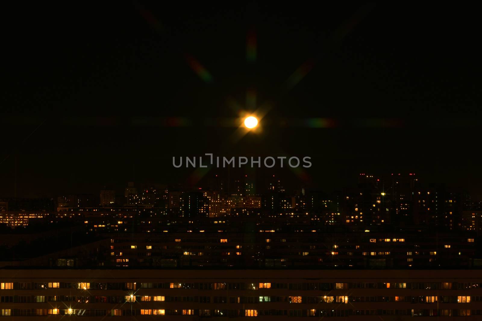 Beautiful night city panorama under shiny moon