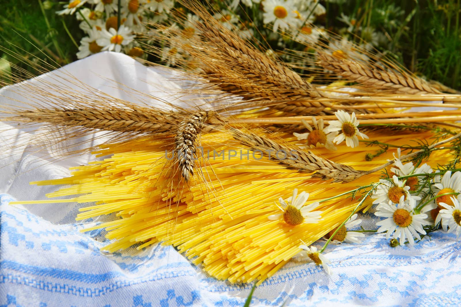 Spaghetti ,wheat and chamomiles outdoors healthy eating concept