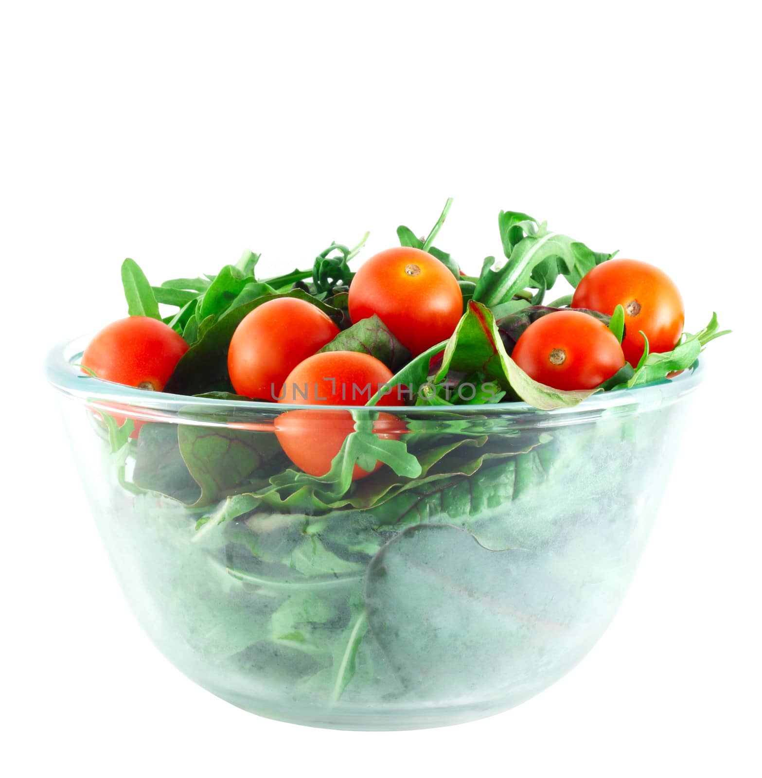 Rucola ,Chard and cherry tomatoes salad in transparent bowl isolated on white