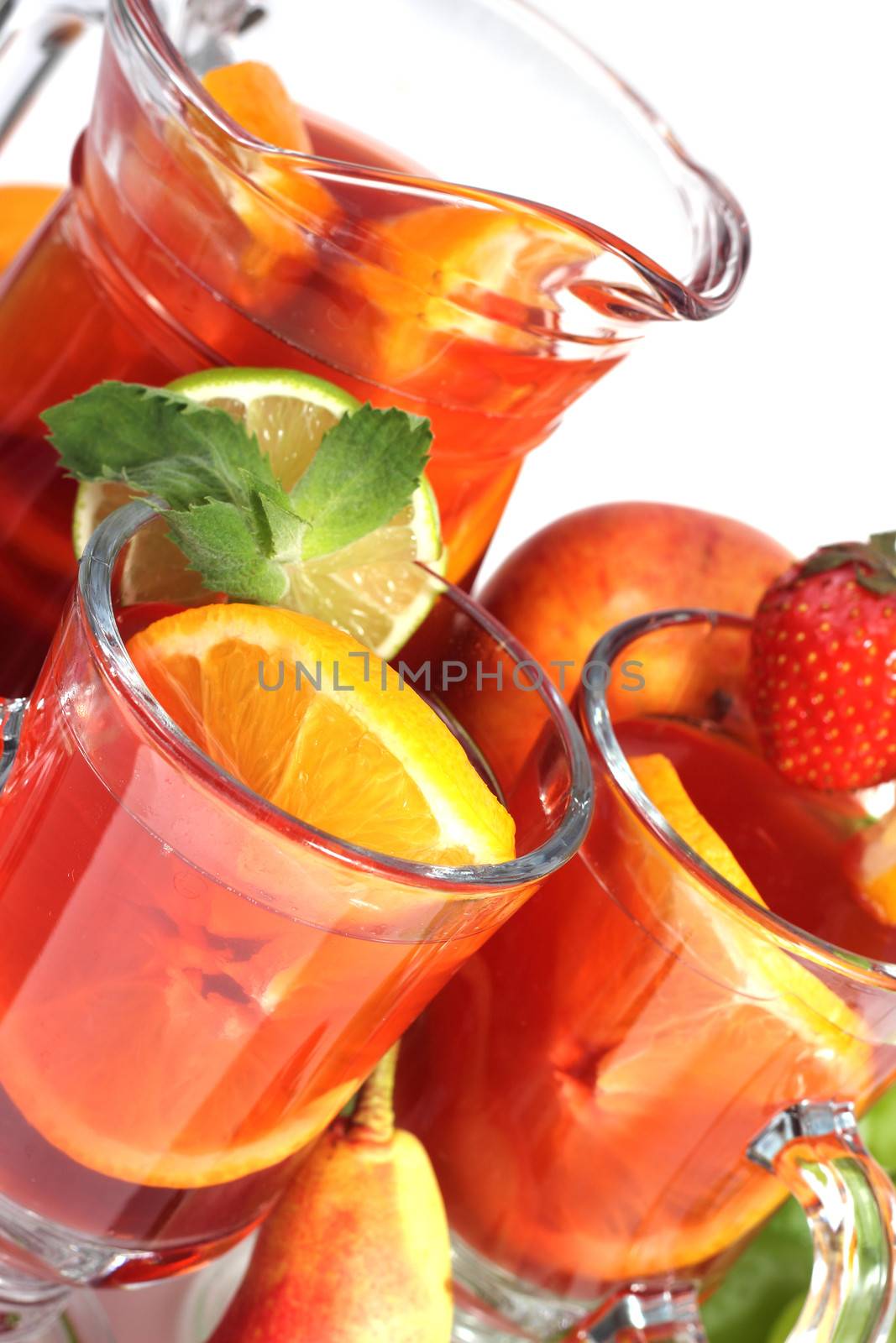 Sangria summer wine in pitcher and glasses and fruits isolated on white