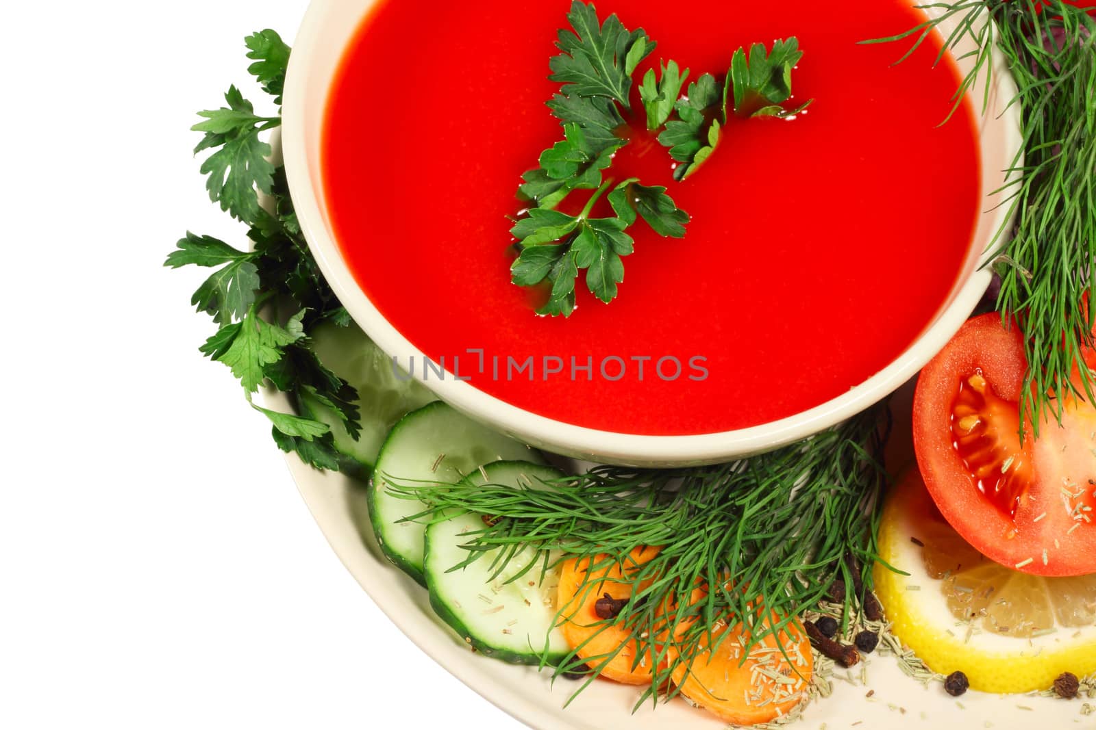 Fresh tomato soup with different vegetables isolated on white