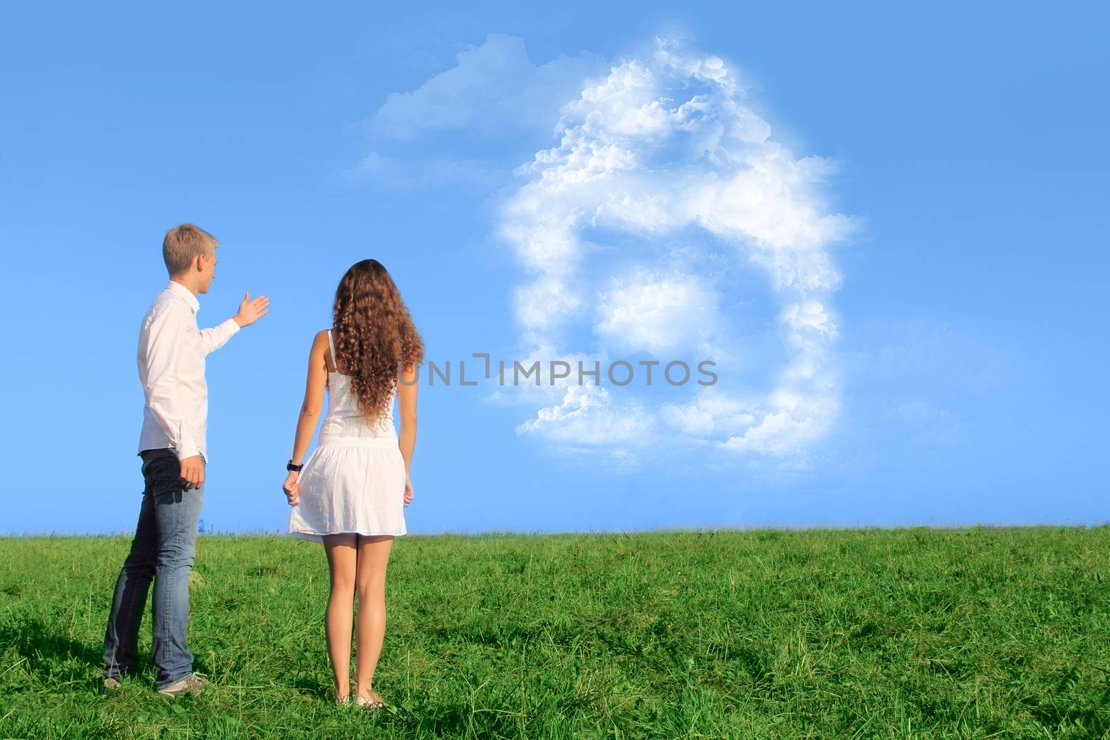 Young couple on field dreaming about their new house