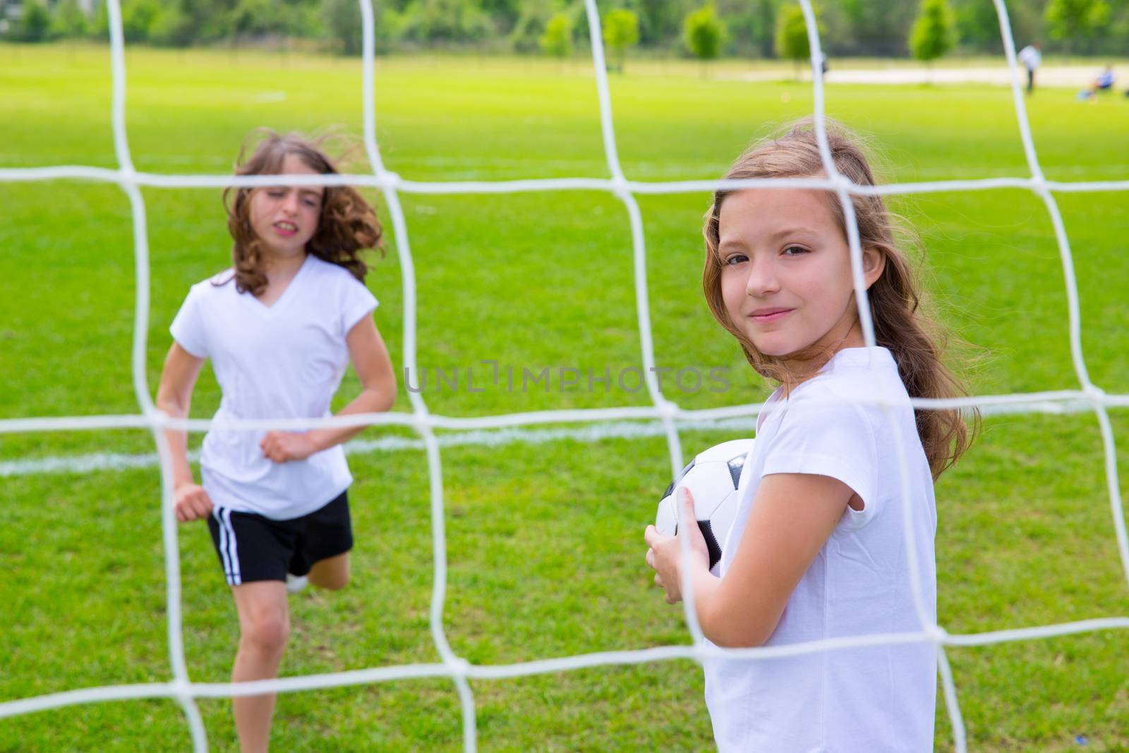 Soccer football kid girls playing on field by lunamarina