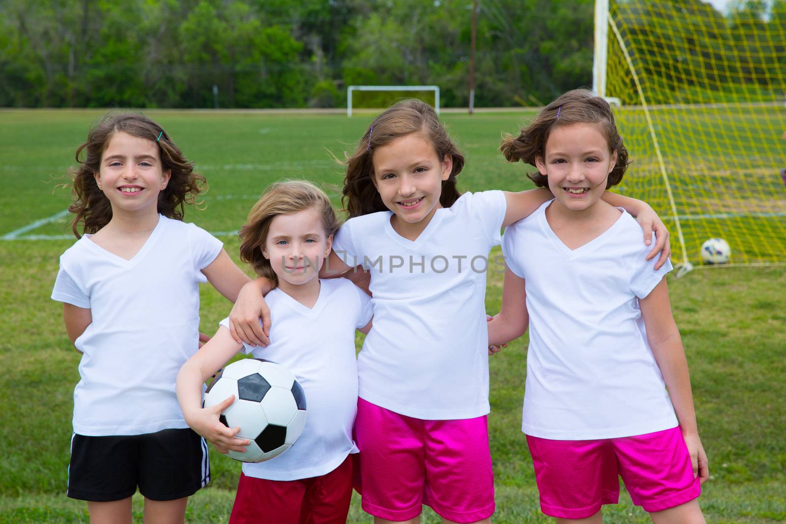 Soccer football kid girls team at sports fileld by lunamarina