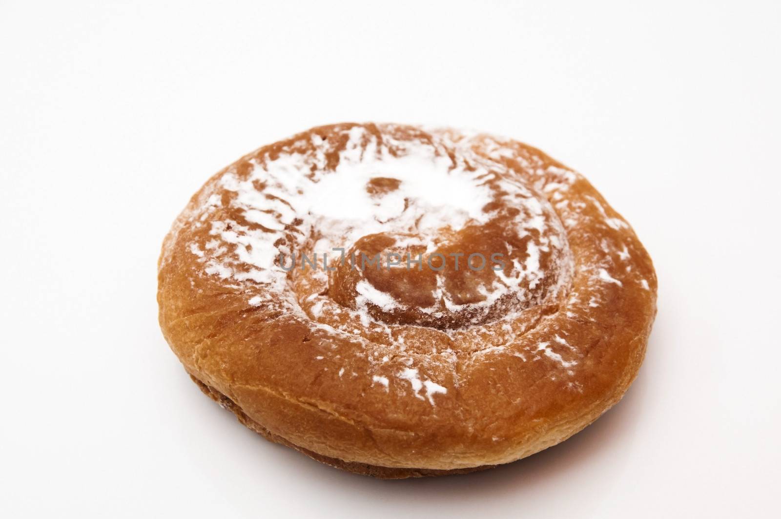 ensaimada with sugar on a white background