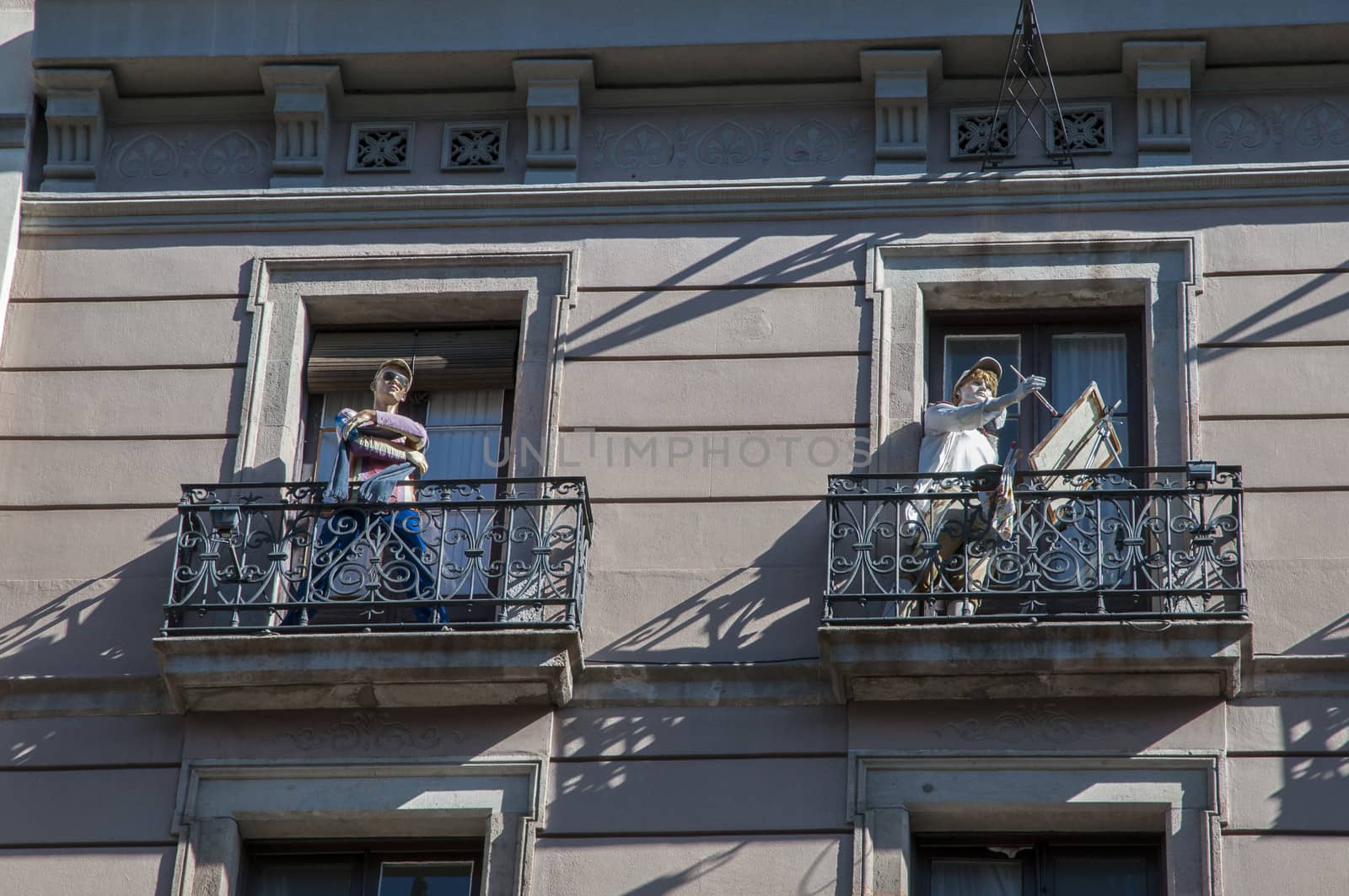 dolls on the balconies in a building in Barcelona