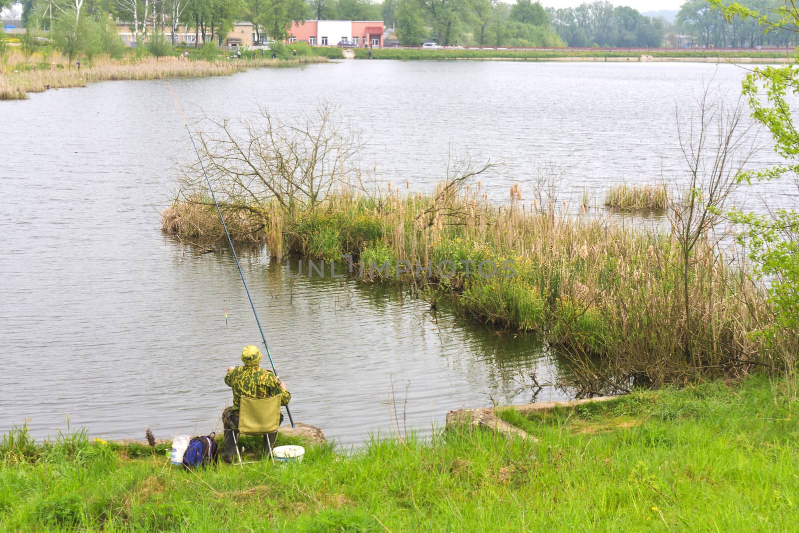A fisherman fishing on the lake landscape