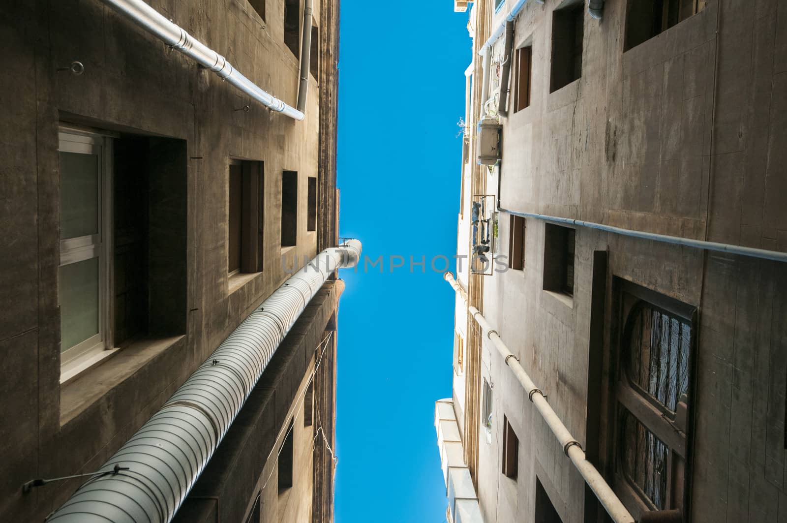 between buildings watching the sky with hardly any space