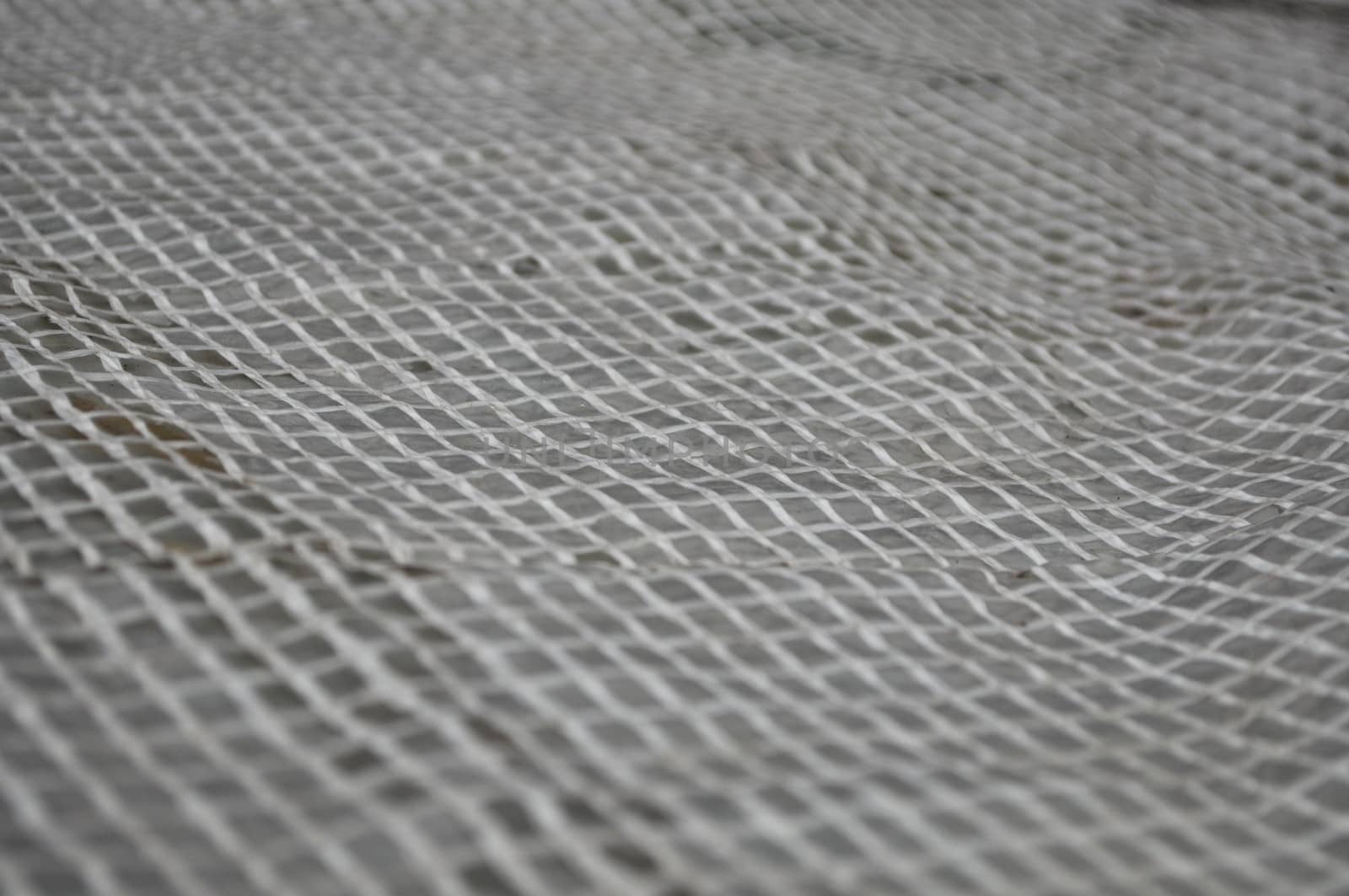 Light wicker grille on a gray background. Reinforced tape in the lumen.