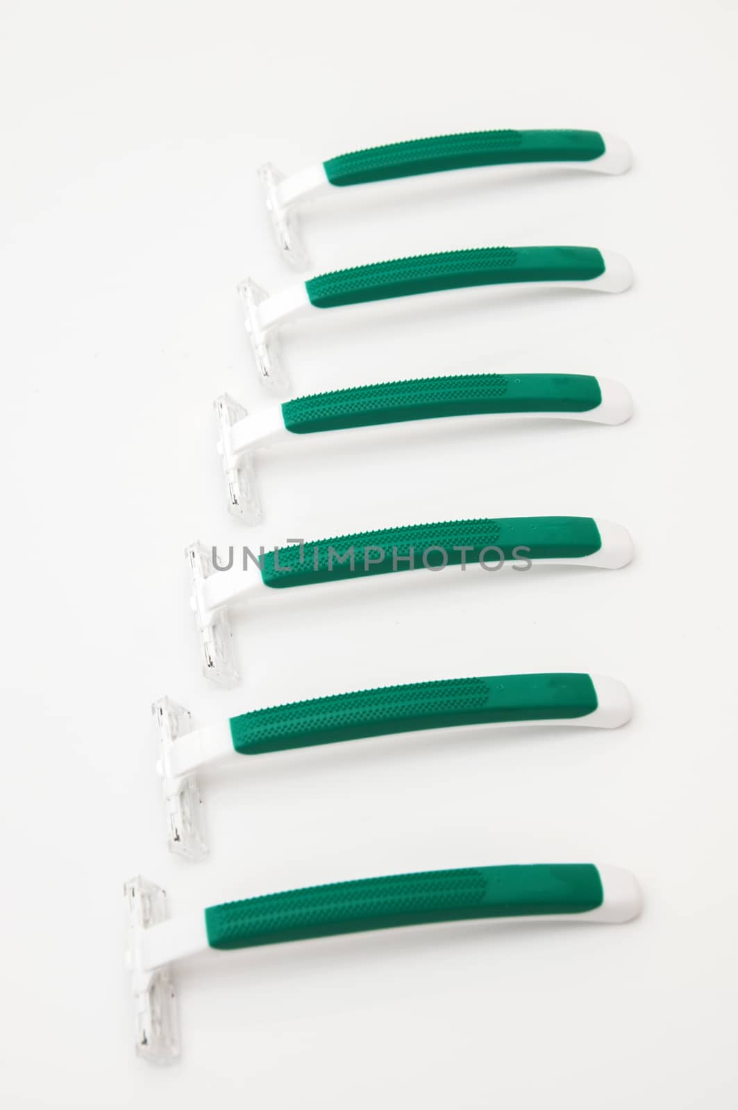 green razors on a white background