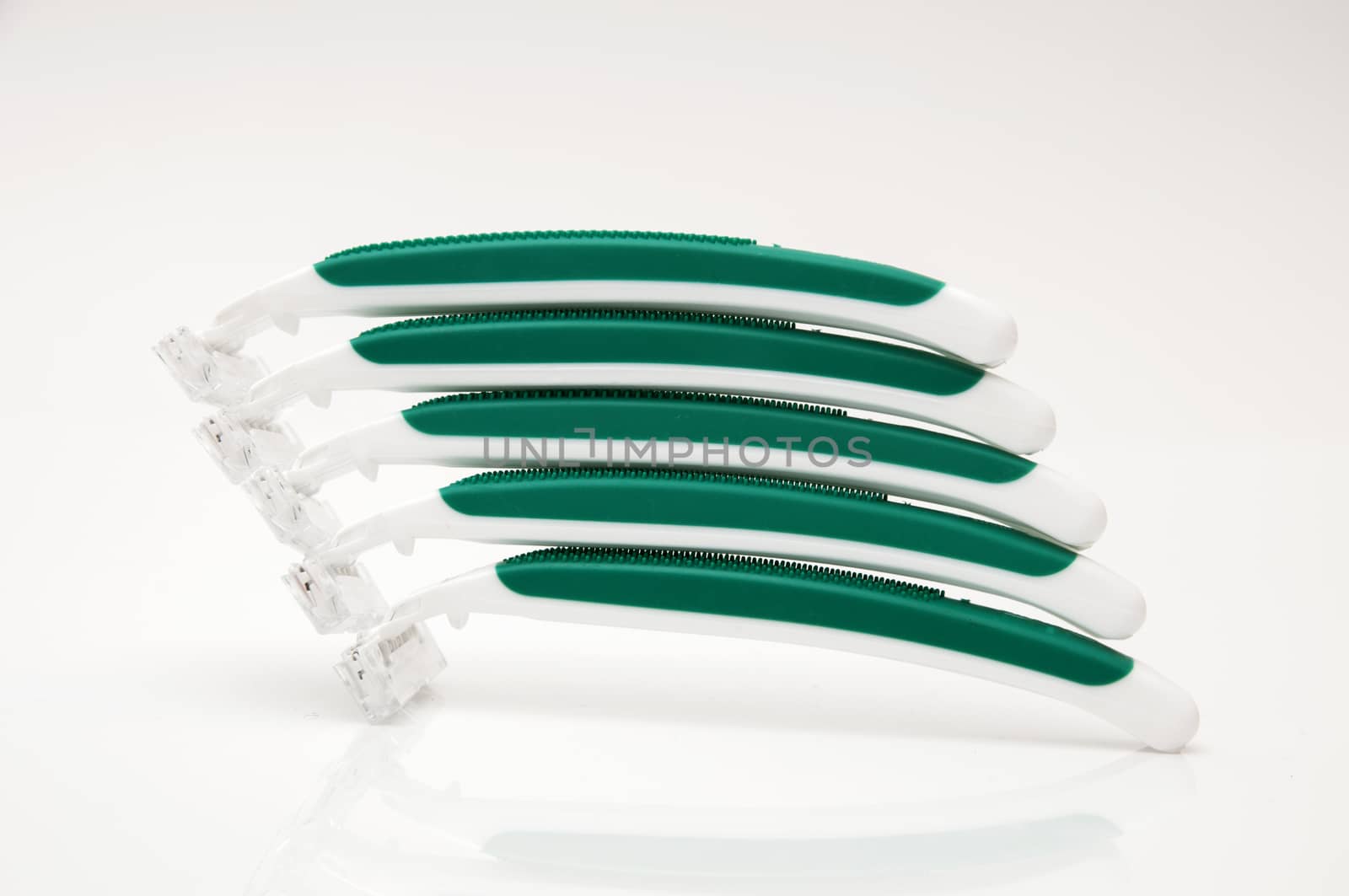 green razors on a white background
