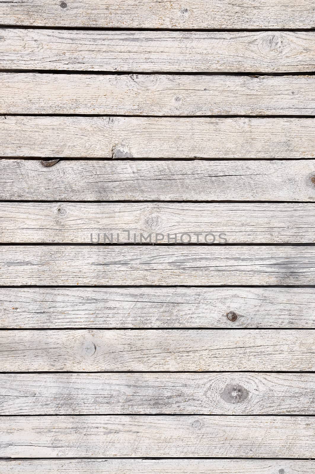 Old cracked wooden plank in gray as background.