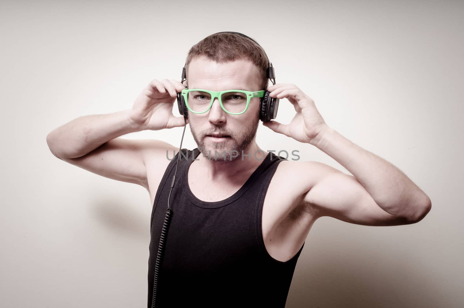 hipster stylish fashion blonde man with headphones on gray background