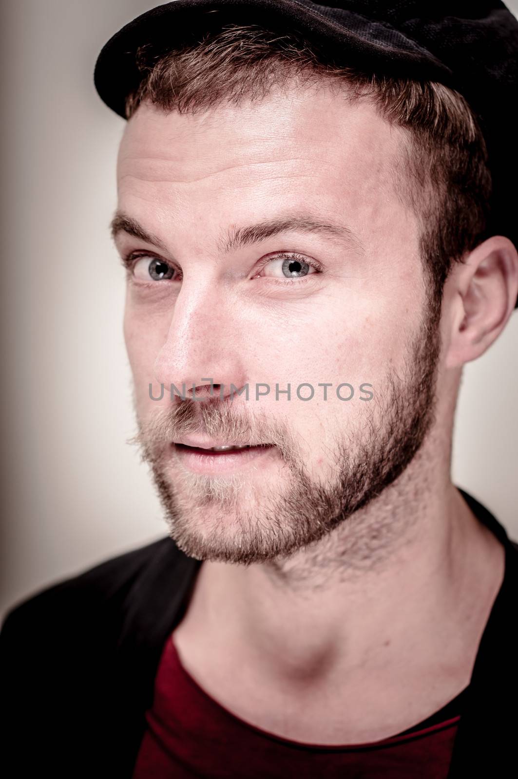 portrait closeup of hipster modern stylish blonde man on gray background