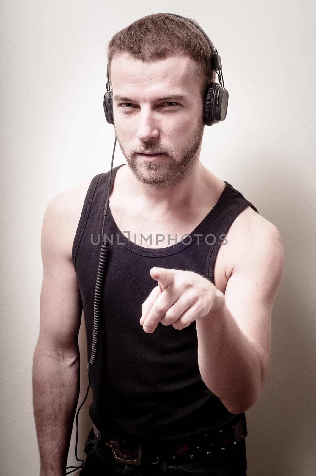 hipster stylish fashion blonde man with headphones on gray background