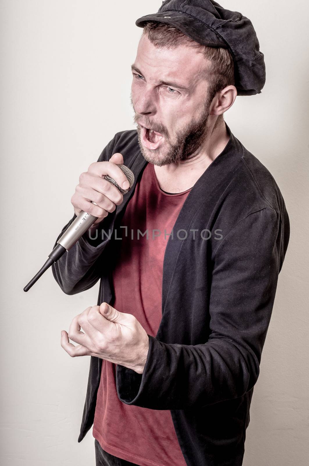 hipster stylish singer on gray background