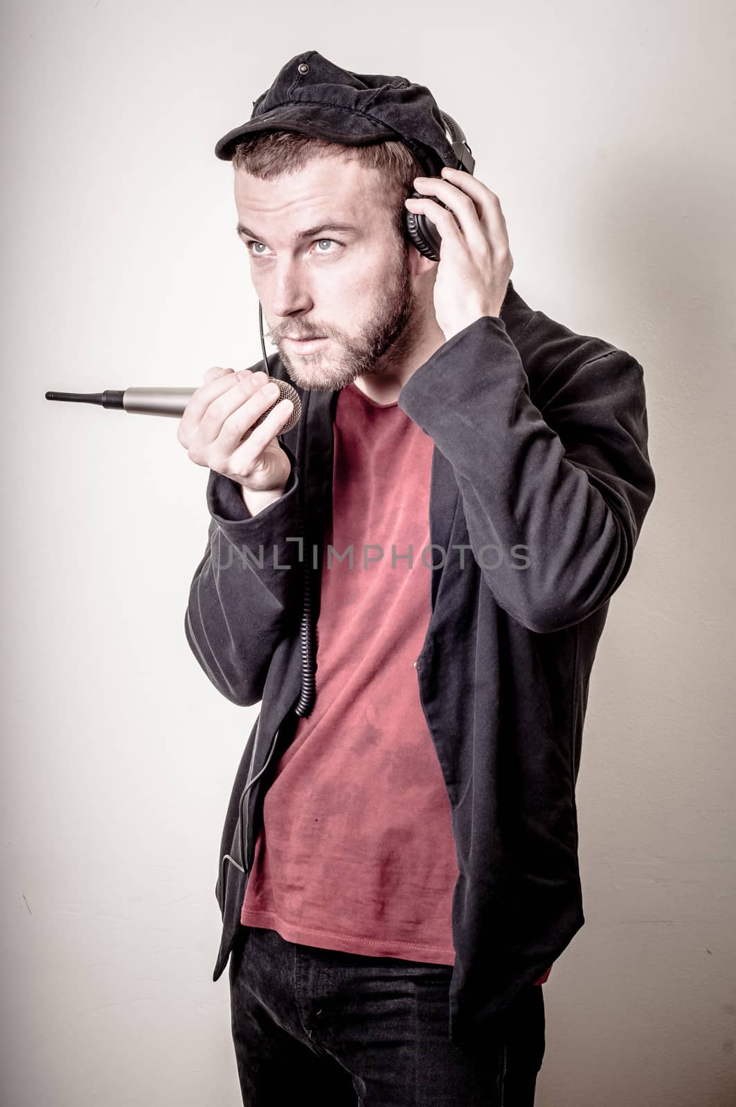hipster stylish fashion blonde man with headphones on gray background