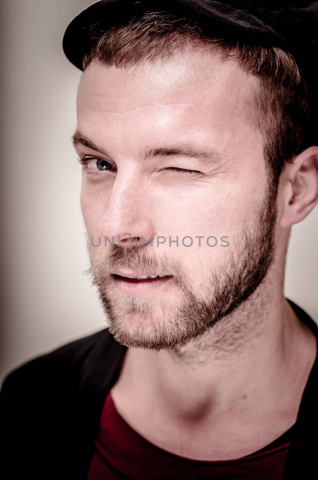 portrait closeup of hipster modern stylish blonde man on gray background