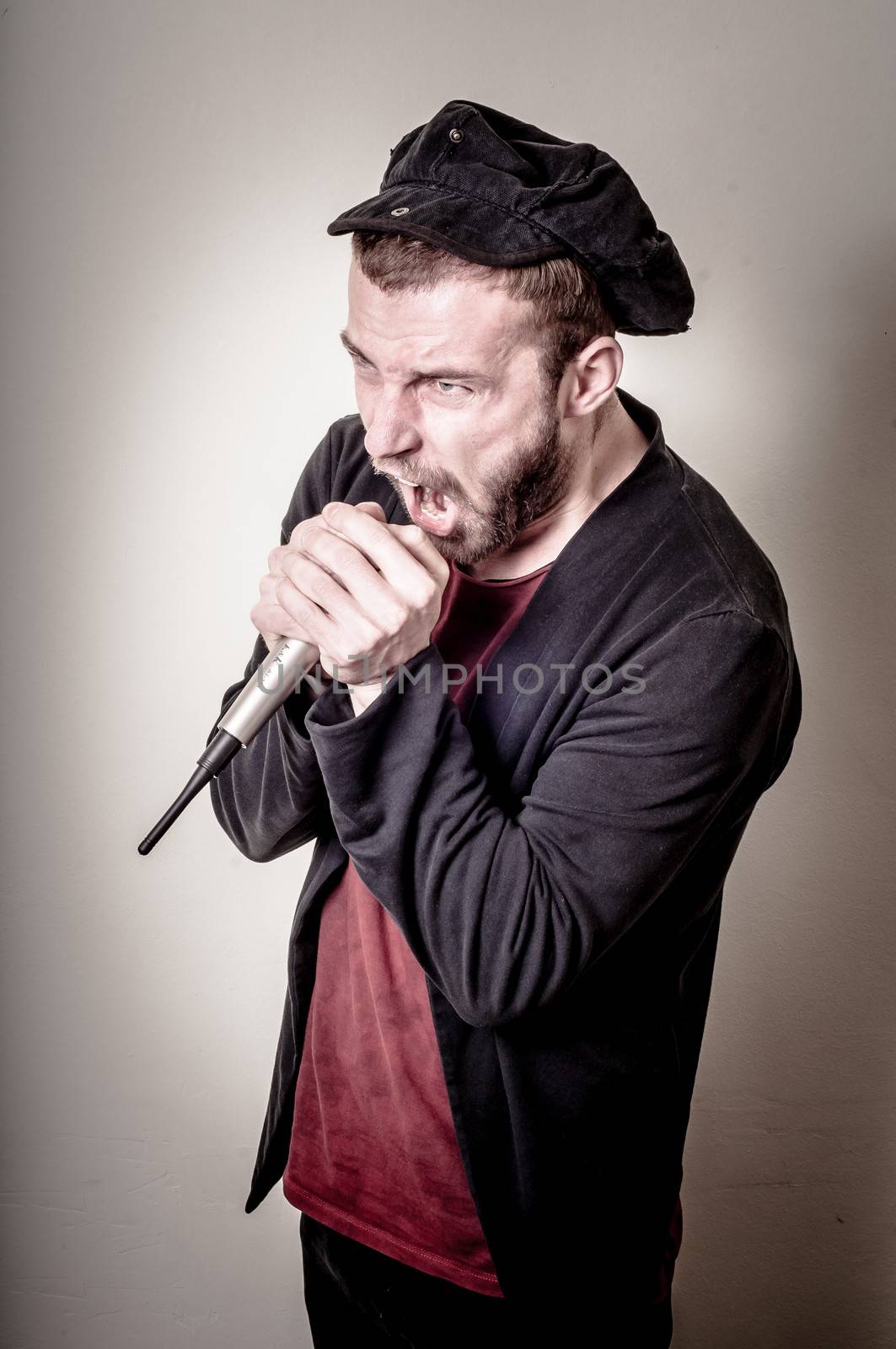 hipster stylish singer on gray background