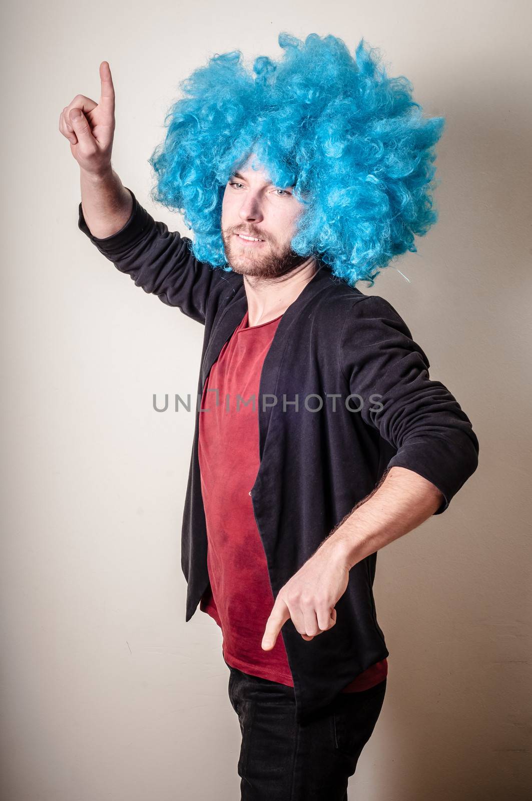 hipster stylish funny man with blue wig on gray background