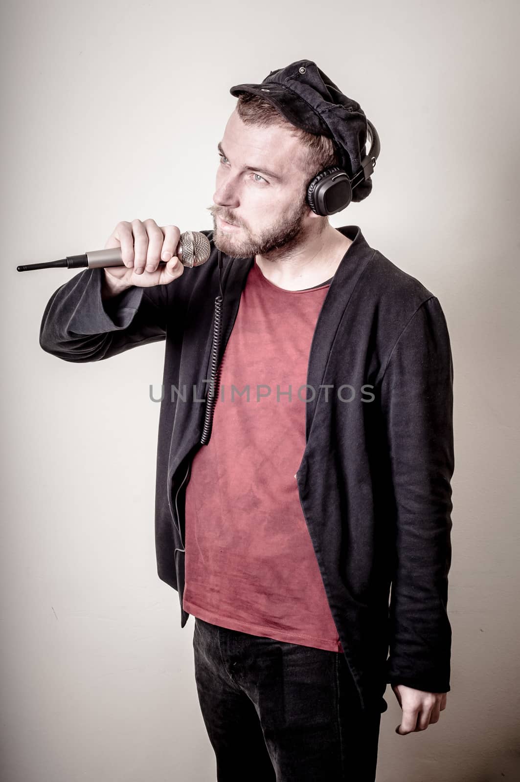 hipster stylish fashion blonde man with headphones on gray background