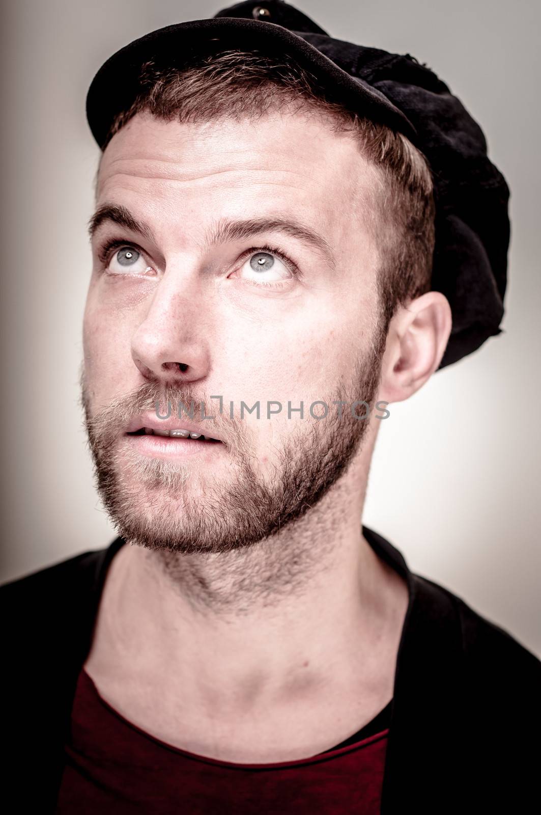 portrait closeup of hipster modern stylish blonde man on gray background