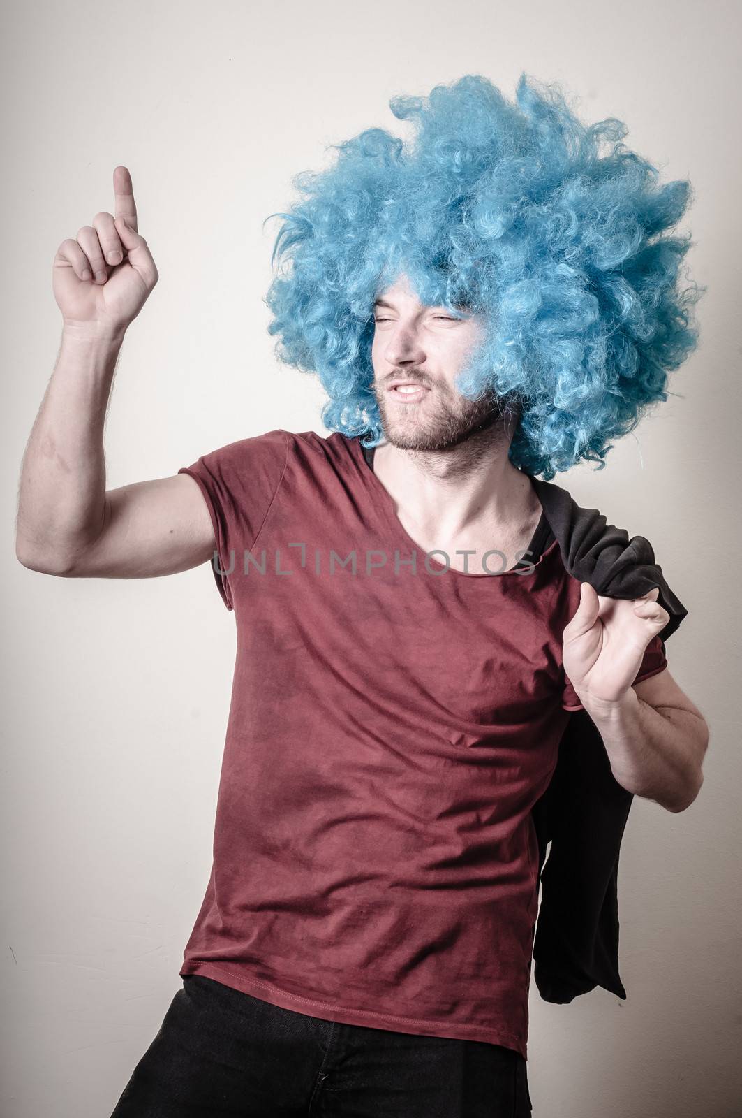 hipster stylish funny man with blue wig on gray background