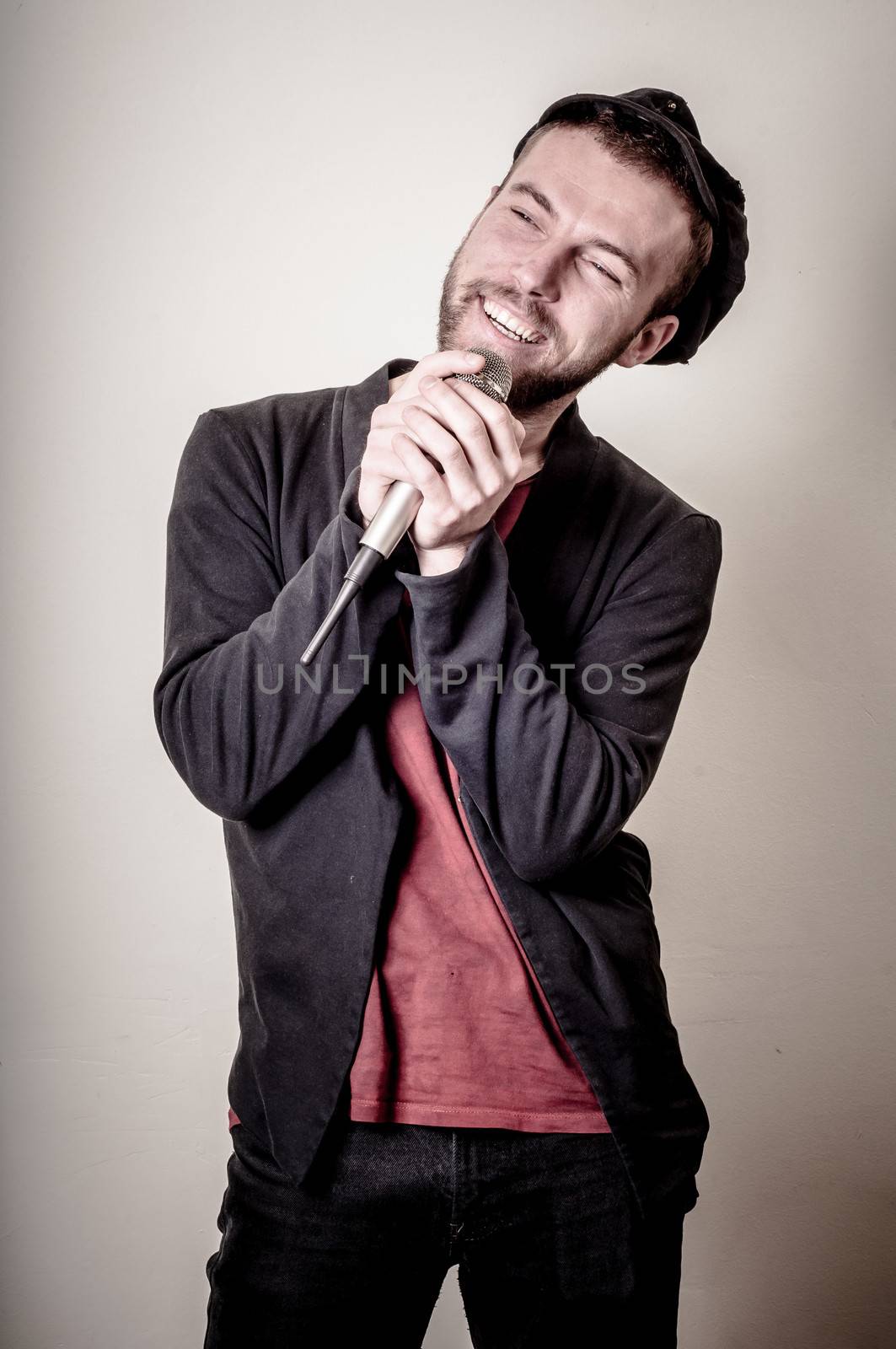 hipster stylish singer on gray background
