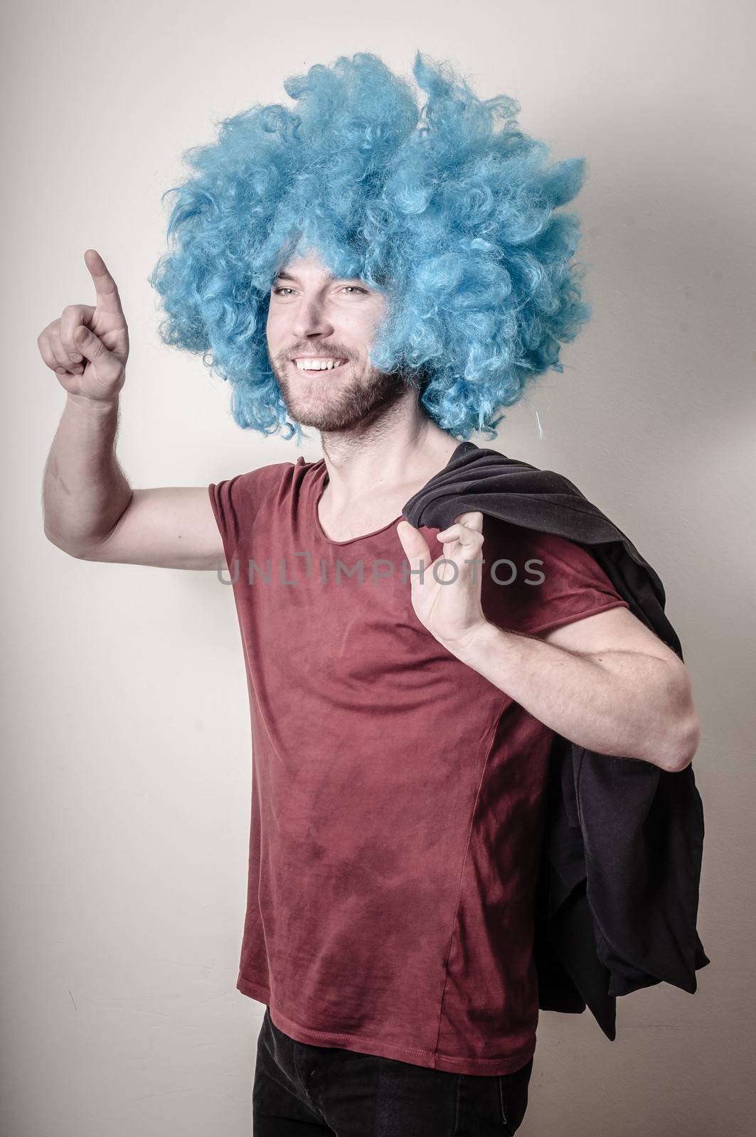 hipster stylish funny man with blue wig on gray background