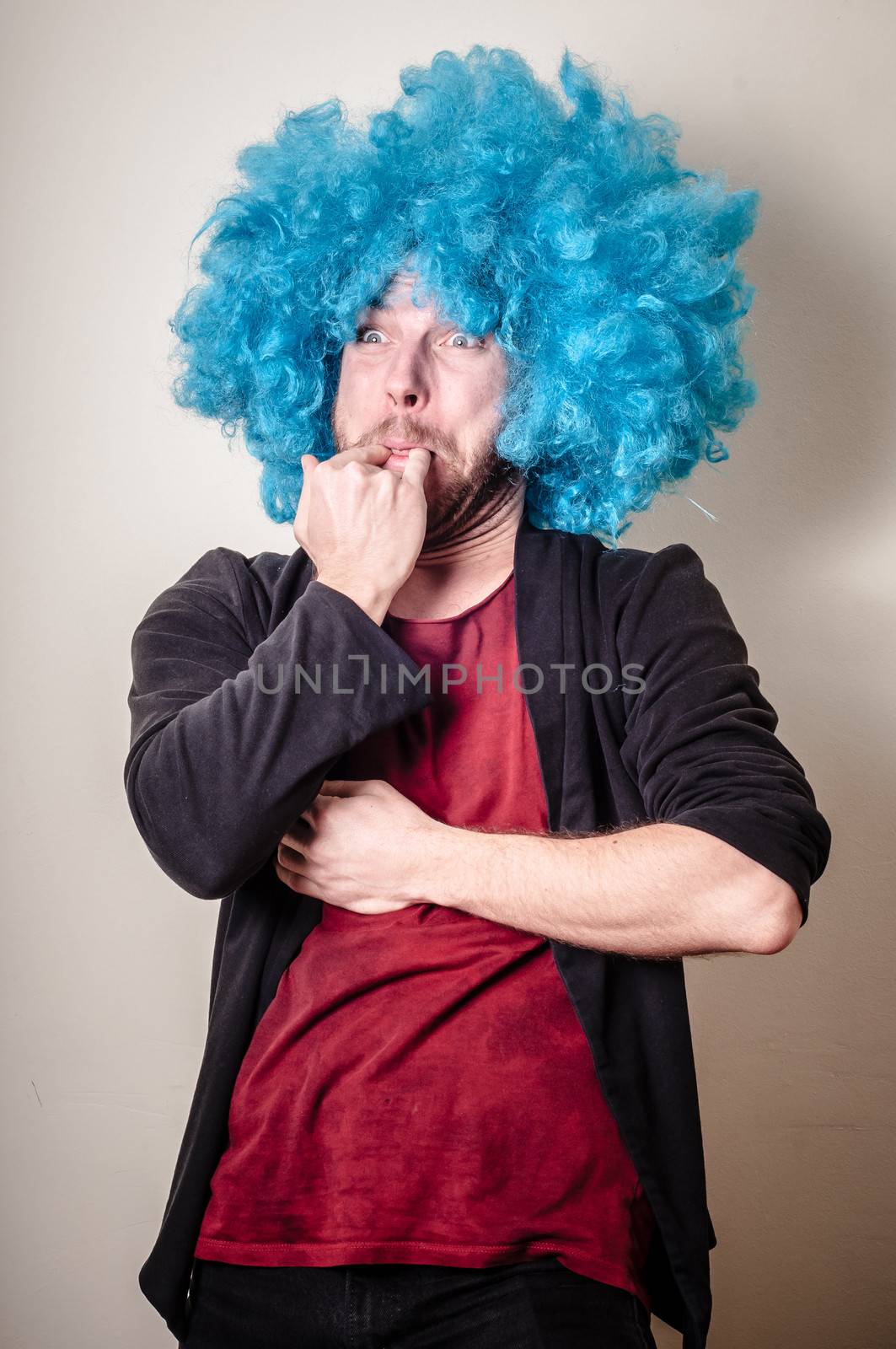 hipster stylish funny man with blue wig on gray background
