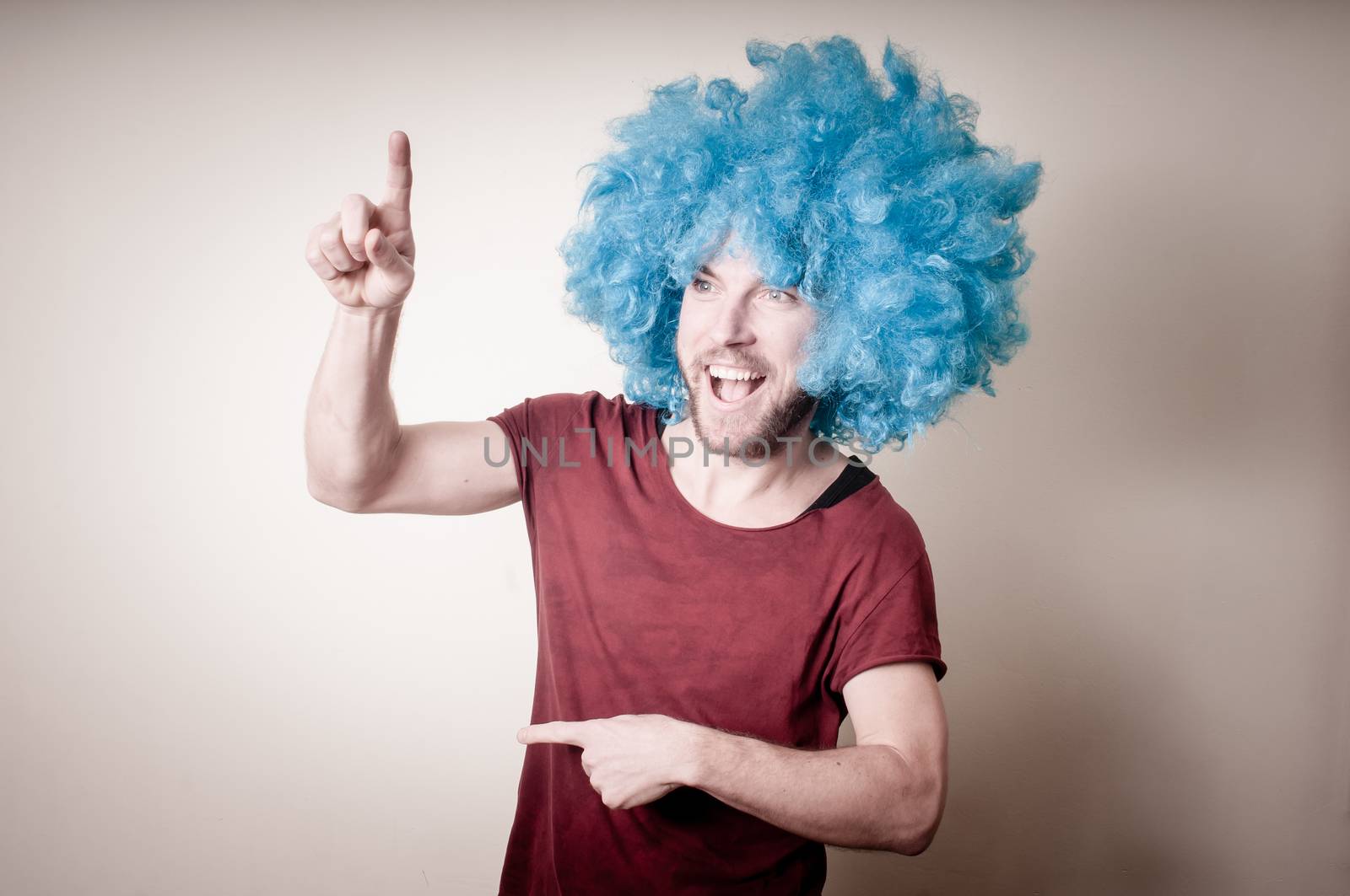 hipster stylish funny man with blue wig on gray background