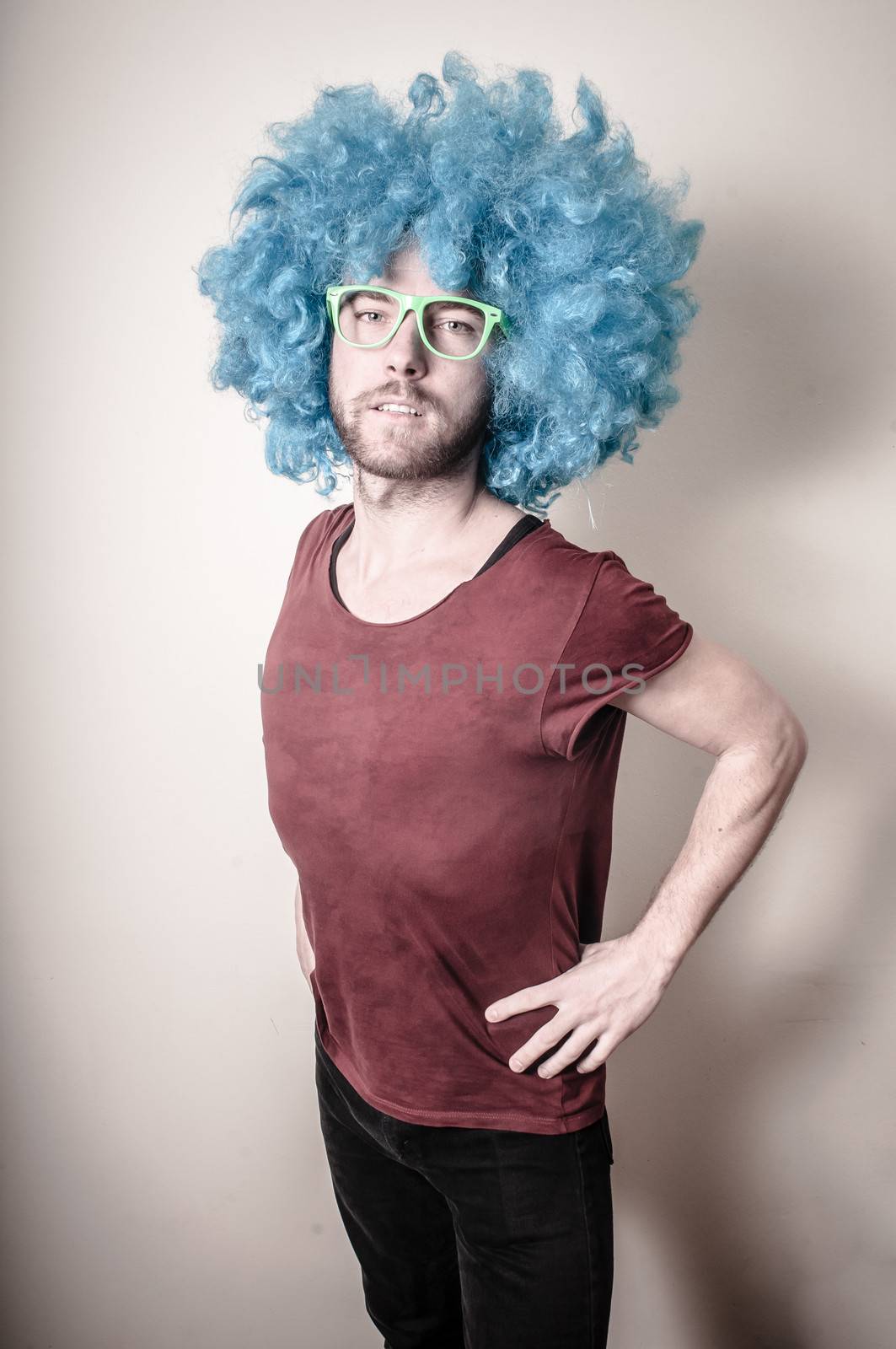 hipster stylish funny man with blue wig on gray background