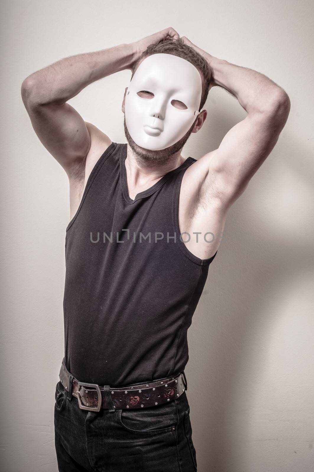 man with white mask on gray background