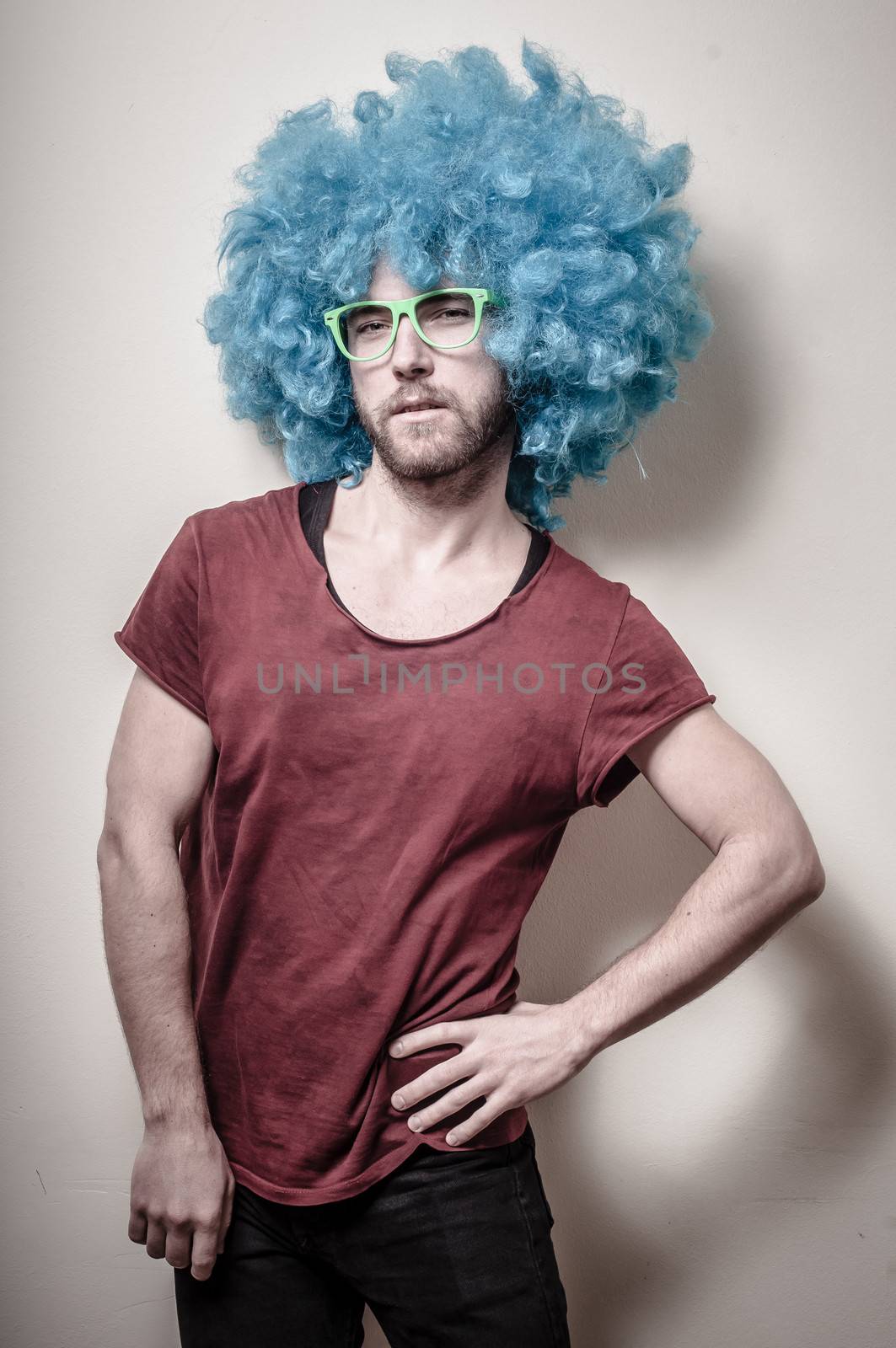 hipster stylish funny man with blue wig on gray background