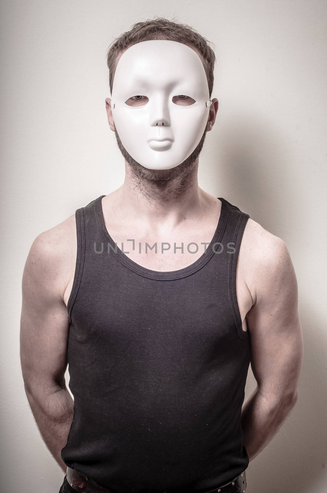 man with white mask on gray background